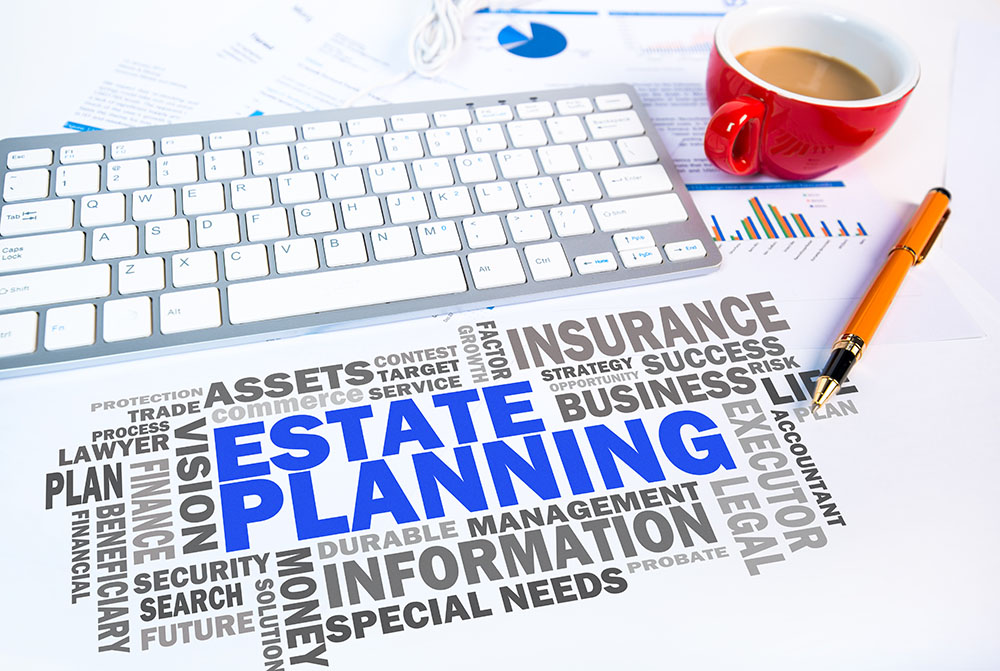 Estate planning words next to keyboard and coffee mug