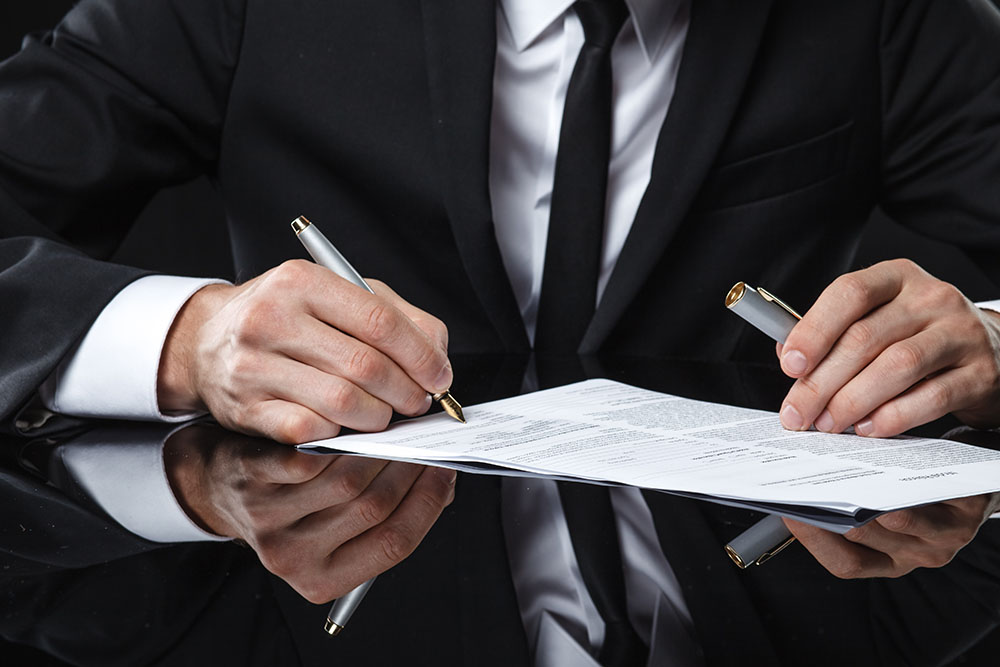 Man signing estate document